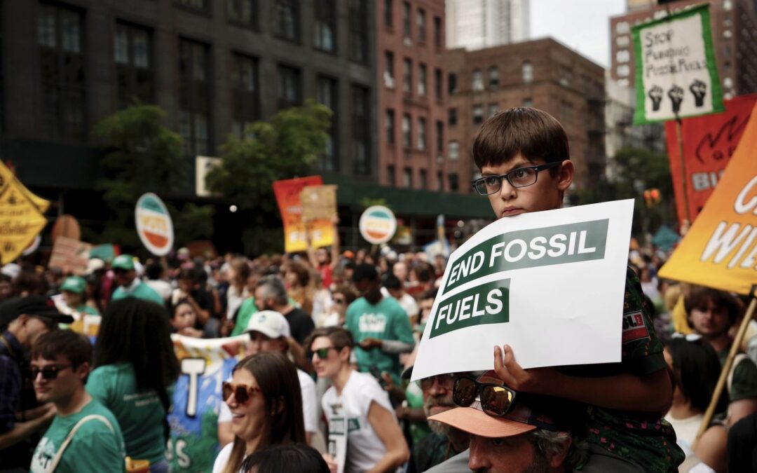 Tens of thousands march to kick off climate summit, demanding end to warming-causing fossil fuels